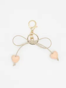 Close-up of a macaron heart bow keychain featuring a golden lobster clasp and key ring.