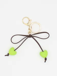 Detailed view of a cute ins style macaron green heart bow keychain with golden clasp