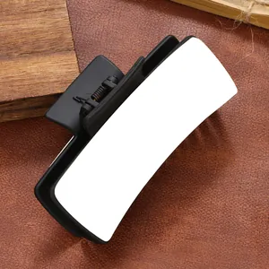 Macro view of a matte black hair claw clip with a white PU surface for DIY heat transfer.