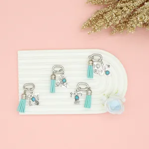 Western ethnic style silver initial charms with turquoise stones and teal tassels