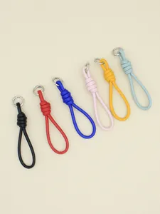 Close-up detail of colorful PU leather braided wrist strap keychains and bag charms