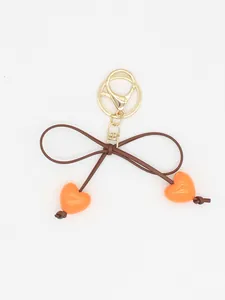 Cute orange heart charms and brown bow-tie keychain with gold-plated metal clasp