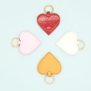 Four heart-shaped PU leather magnetic hat clips in vibrant colors with gold rings