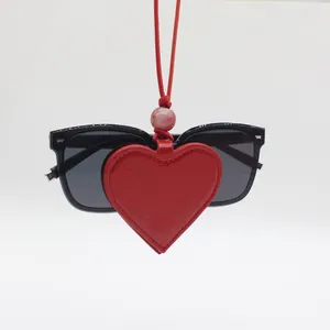 Detailed view of red heart magnetic PU leather eyeglass clip pendant with neck cord