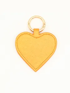 Detailed close-up of a vibrant yellow glitter heart PU leather magnetic hat clip with ring