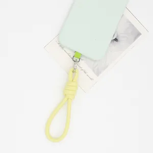 Close-up of a light yellow PU leather braided wrist strap with a stylish knot and metal clasp.