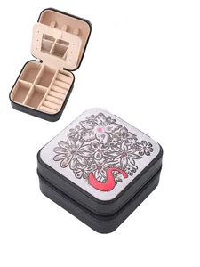 Portable square jewelry box with embossed floral pattern and pink letter S detail, chic.