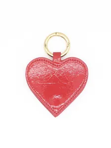 Close-up detail of the red heart-shaped PU leather magnetic hat clip with gold hardware.