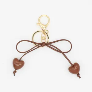 Cute brown bow keychain with macaron heart pendants for bags and car keys minimalist charm