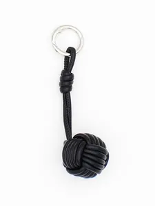 Close-up of black PU leather hand-woven ball bag charm with silver clasp