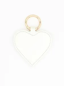 Detailed close-up of a white heart-shaped PU leather magnetic hat clip with golden ring