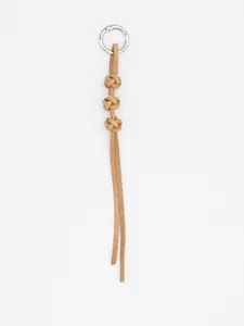 Close-up of handmade braided cowhide leather keychain with three knots and metal ring
