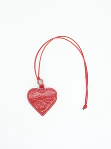 Close-up of red heart-shaped PU leather glasses holder pendant with neck cord