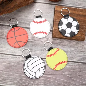 Detailed view of assorted sports-themed leather keychains including soccer and baseball.