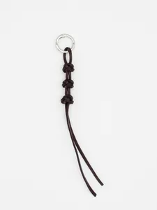 Detail view of handmade dark brown braided leather keychain with silver ring buckle