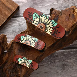 Vintage leather hair clip set with printed sunflowers on rustic wood background