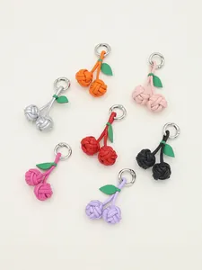 Detailed view of handcrafted PU leather cherry charms in seven vibrant colors