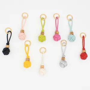 Colorful PU leather woven ball bag charms with wood beads in various bright colors.
