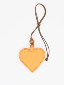 Detailed view of orange heart-shaped PU leather magnetic glasses clip pendant.