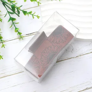 Detailed view of a vintage sunflower pattern PU leather hair claw clip in a clear gift box.