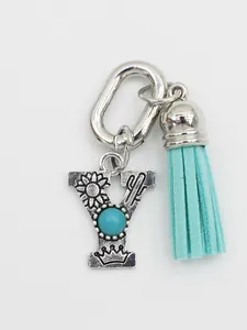 Detailed view of ethnic style letter Y charm with turquoise and aqua tassel