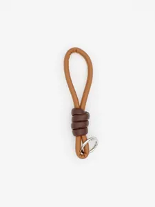Detail of brown PU leather braided keychain with dark brown knot and silver ring