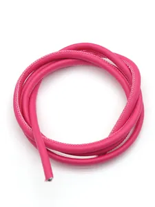 Macro detail view of pink Saffiano PU leather cord with fine white stitching for DIY.