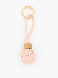Detail of hand-woven pink PU leather ball charm with wooden bead ornament