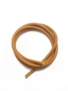 Macro close-up of brown cross-grain PU leather cord with yellow decorative stitching