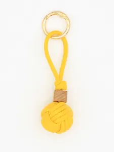 Detailed close-up of a handmade yellow woven ball PU leather keychain with a wooden bead