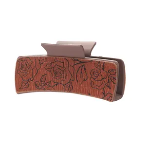 Vintage Western-style hair claw clip with embossed rose pattern on PU leather inlay