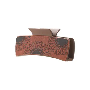 Western vintage style hair claw clip featuring embossed sunflower on PU leather inlay