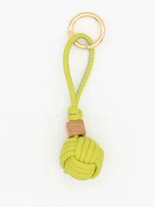 Detailed view of lime green PU leather woven ball keychain with a natural wooden bead