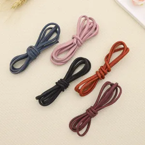 Detailed view of matte stitched round leather cords in various retro colors for DIY crafts