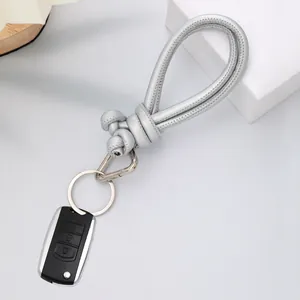 Detailed macro view of silver hand-knotted PU leather keychain lanyard with metal ring