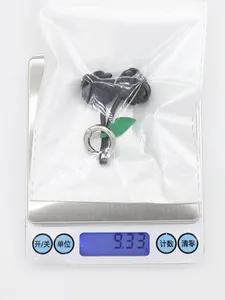 Handmade PU leather cherry bag charm keychain on an electronic scale showing 9.33g weight