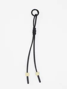 Detailed view of hand-braided black PU leather cord pendant with cream beads and ring.