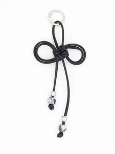 Detailed view of a hand-woven black PU rope keychain with butterfly knot and marbled beads