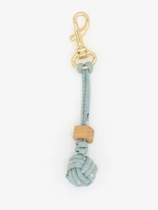 Detail view of a handcrafted blue braided rope keychain with a wooden bead and monkey's fist knot