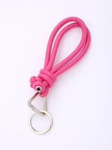 Close-up detail of a bright pink hand-braided PU leather phone lanyard with silver ring