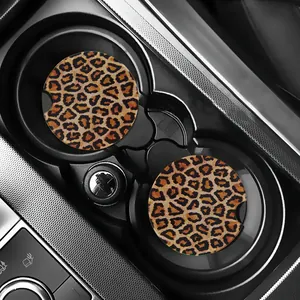 Set of leopard print car coasters shown inside a black center console cup holder