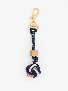 Detailed macro view of a handmade braided floral PU leather ball charm with wooden bead