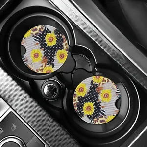 Sunflower and leopard print car coasters placed inside a black car cup holder.