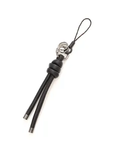 Close-up of DIY handmade black woven leather rope pendant with sleek silver metal tips