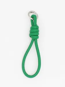 Macro view of the green braided PU leather wrist strap keychain featuring a silver ring