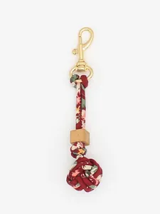 Hand-woven floral fabric bag charm with wooden bead and gold metal clasp