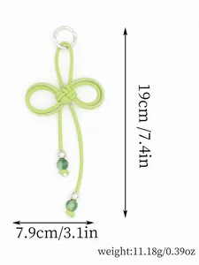 Detailed macro view of hand-woven green PU rope charm featuring a bow knot and beads