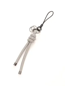 Detailed close-up of grey handmade braided leather cord keychain charm with silver metal rings