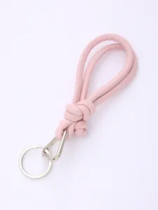 Detail shot of pink hand-knotted PU leather phone strap with silver carabiner keychain