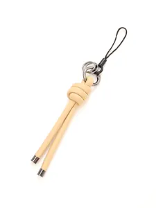 Detailed macro view of the handmade beige braided leather knot charm keychain strap